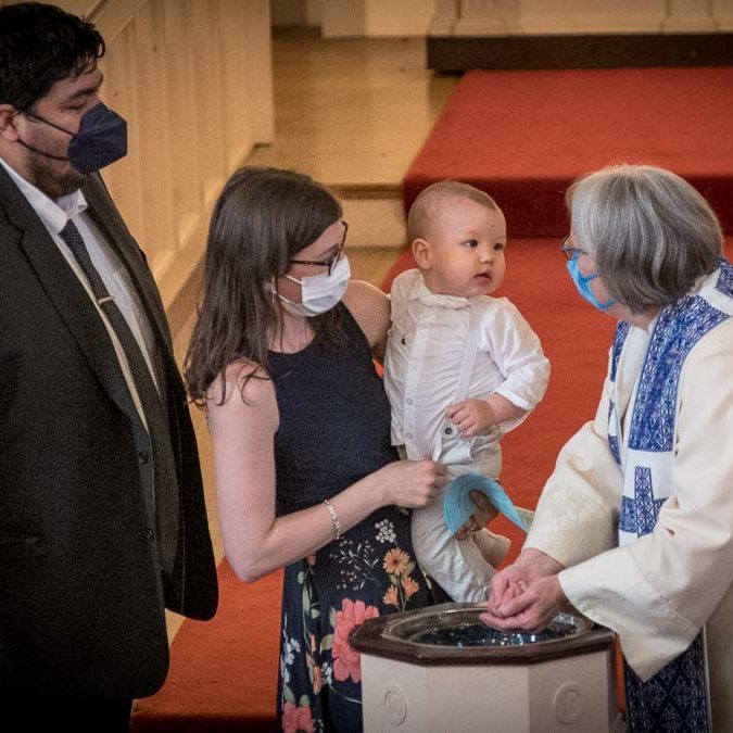 infant being baptized by Pastor Sehlly