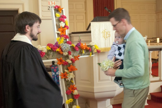 Everyone is invited to take a flower as they enter the sanctuary and, early in the service, one by one those flowers are added to the cross.